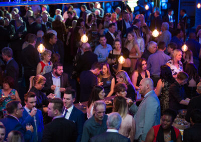 Formally dressed group of people at a night time gala event.